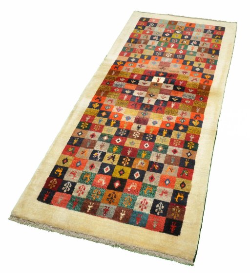 Corner detail of 2000s Persian Gabbeh rug showing border pattern and Wool pile