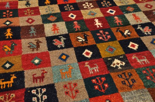 Surface texture of 2000s Persian Gabbeh rug with natural Wool and intricate pattern