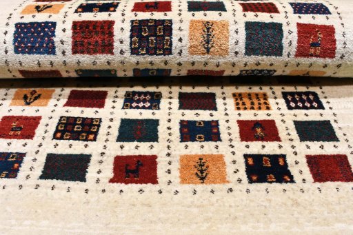 Corner detail of 2000s Persian Gabbeh rug showing border pattern and Wool pile