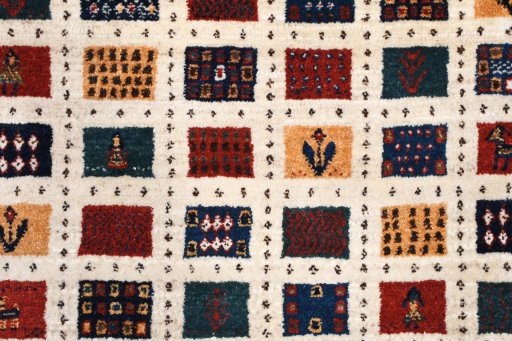 Backside of handmade 2000s Persian Gabbeh rug showing knot structure and weave density