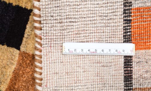 Corner detail of 2000s Persian Gabbeh rug showing border pattern and Wool pile