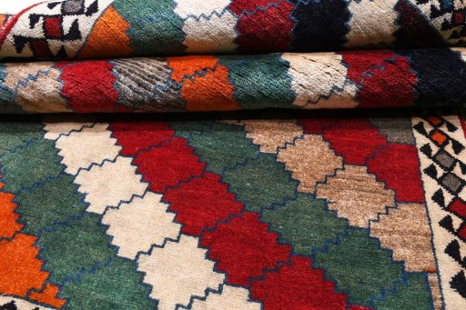 Corner detail of 2000s Persian Gabbeh rug showing border pattern and Wool pile