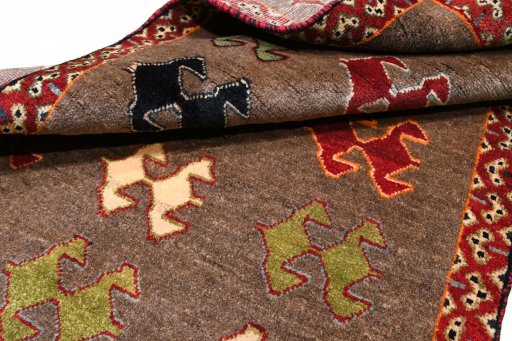 Corner detail of 2000s Persian Gabbeh rug showing border pattern and Wool pile