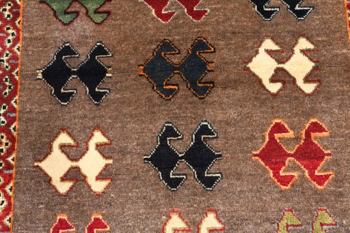 Backside of handmade 2000s Persian Gabbeh rug showing knot structure and weave density