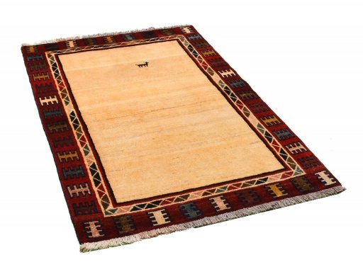 Corner detail of 2000s Persian Gabbeh rug showing border pattern and Wool pile