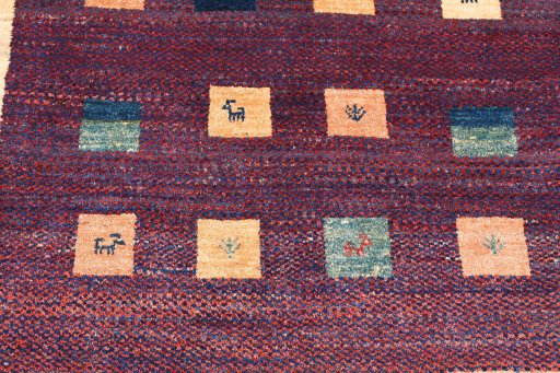 Backside of handmade 2000s Persian Gabbeh rug showing knot structure and weave density