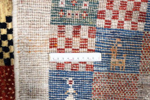Corner detail of 2000s Persian Gabbeh rug showing border pattern and Wool pile