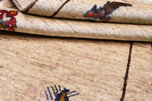Corner detail of 2000s Persian Gabbeh rug showing border pattern and Wool pile