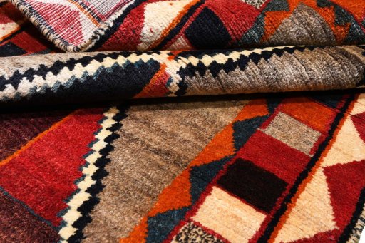 Corner detail of 2000s Persian Gabbeh rug showing border pattern and Wool pile