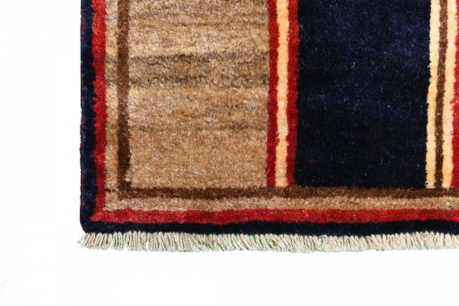 Corner detail of 2000s Persian Gabbeh rug showing border pattern and Wool pile