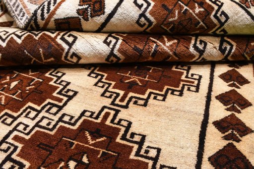 Corner detail of 2000s Persian Gabbeh rug showing border pattern and Wool pile