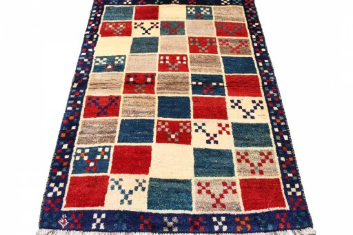 Surface texture of 2000s Persian Gabbeh rug with natural Wool and intricate pattern