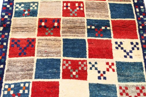 Backside of handmade 2000s Persian Gabbeh rug showing knot structure and weave density