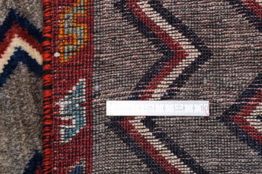 Corner detail of 2000s Persian Gabbeh rug showing border pattern and Wool pile