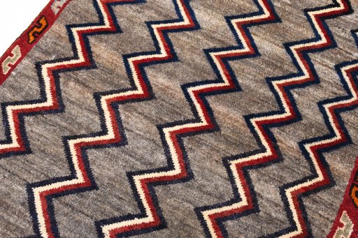 Backside of handmade 2000s Persian Gabbeh rug showing knot structure and weave density