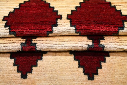 Corner detail of 2000s Persian Gabbeh rug showing border pattern and Wool pile