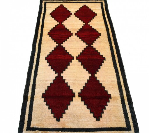 Surface texture of 2000s Persian Gabbeh rug with natural Wool and intricate pattern