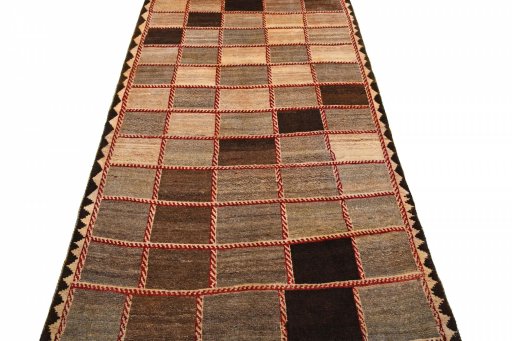 Surface texture of 2000s Persian Gabbeh rug with natural Wool and intricate pattern