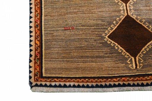 Corner detail of 2000s Persian Gabbeh rug showing border pattern and Wool pile