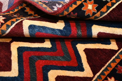 Corner detail of 2000s Persian Gabbeh rug showing border pattern and Wool pile