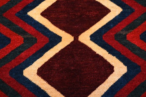 Backside of handmade 2000s Persian Gabbeh rug showing knot structure and weave density
