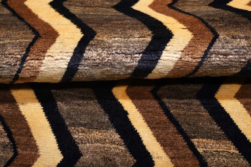 Corner detail of 2000s Persian Gabbeh rug showing border pattern and Wool pile