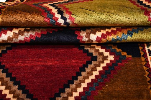 Corner detail of 2000s Persian Gabbeh rug showing border pattern and Wool pile