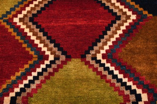 Backside of handmade 2000s Persian Gabbeh rug showing knot structure and weave density