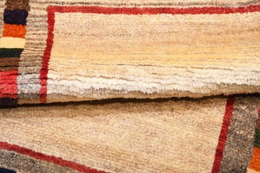Full view of 2000s Persian Gabbeh rug from Iran / Persia, 145 × 85 cm in Beige tones