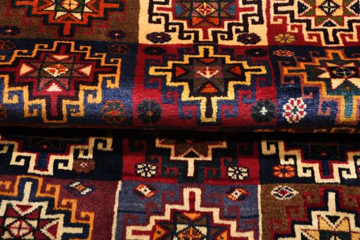 Corner detail of 2000s Persian Gabbeh rug showing border pattern and Wool pile
