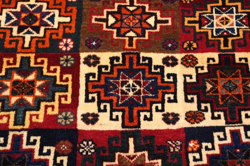 Backside of handmade 2000s Persian Gabbeh rug showing knot structure and weave density