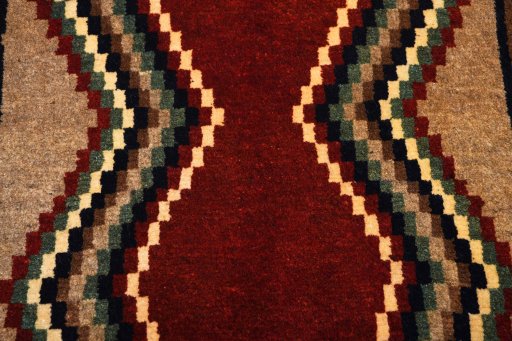 Backside of handmade 2000s Persian Gabbeh rug showing knot structure and weave density