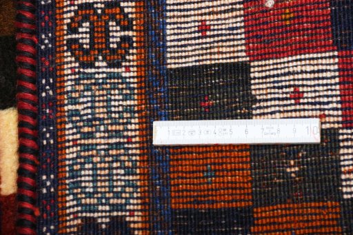 Corner detail of 2000s Persian Gabbeh rug showing border pattern and Wool pile