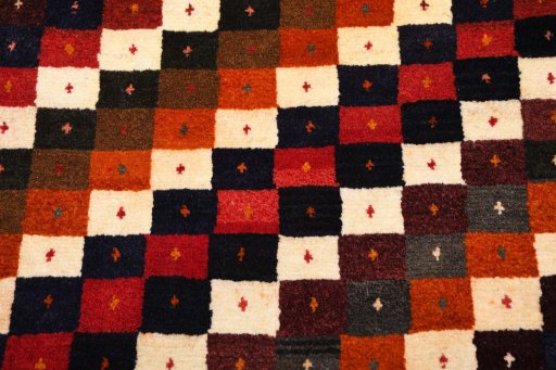 Backside of handmade 2000s Persian Gabbeh rug showing knot structure and weave density