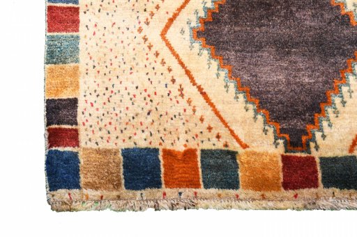 Corner detail of 2000s Persian Gabbeh rug showing border pattern and Wool pile