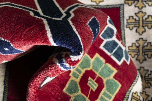Corner detail of 2000s Persian Gabbeh rug showing border pattern and Wool pile