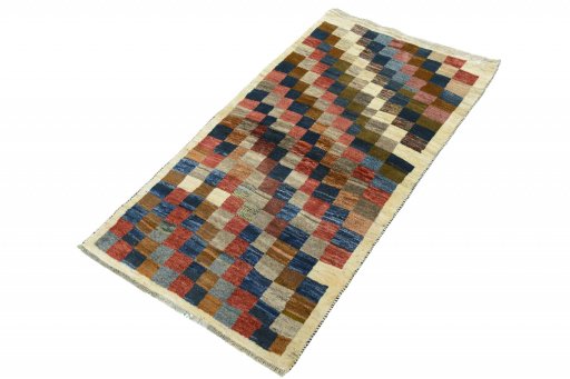 Corner detail of 2000s Persian Gabbeh rug showing border pattern and Wool pile