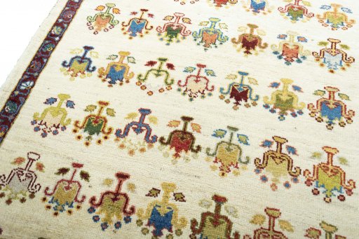 Backside of handmade 2000s Persian Gabbeh rug showing knot structure and weave density