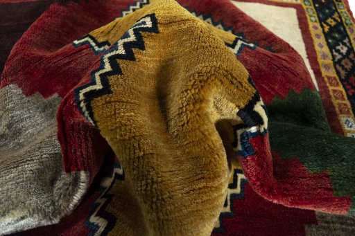 Corner detail of 2000s Persian Gabbeh rug showing border pattern and Wool pile