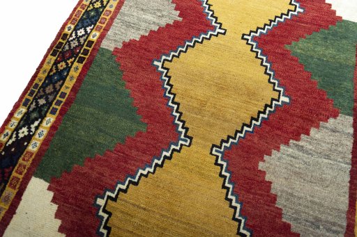 Backside of handmade 2000s Persian Gabbeh rug showing knot structure and weave density