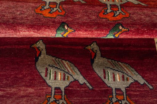 Full view of 2000s Persian Gabbeh rug from Iran / Persia, 158 × 106 cm in Red tones