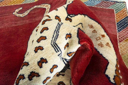 Corner detail of 2000s Persian Gabbeh rug showing border pattern and Wool pile
