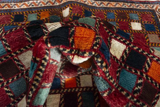 Corner detail of 2000s Persian Gabbeh rug showing border pattern and Wool pile