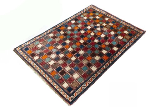 Corner detail of 2000s Persian Gabbeh rug showing border pattern and Wool pile