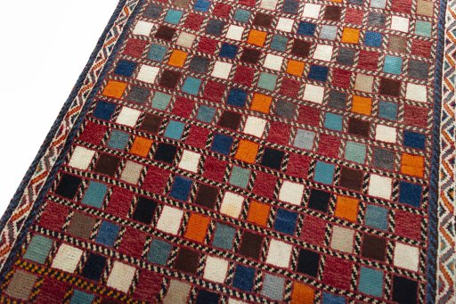 Backside of handmade 2000s Persian Gabbeh rug showing knot structure and weave density