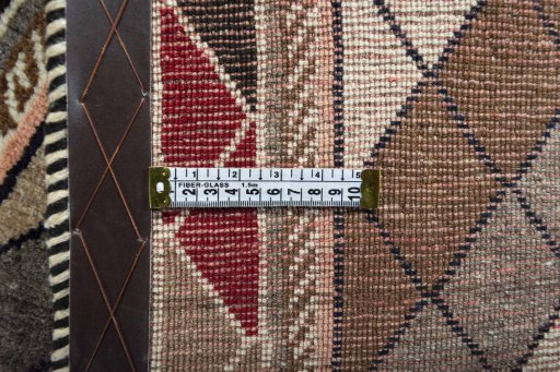 Corner detail of 2000s Persian Gabbeh rug showing border pattern and Wool pile