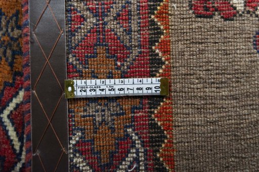 Corner detail of 2000s Persian Gabbeh rug showing border pattern and Wool pile