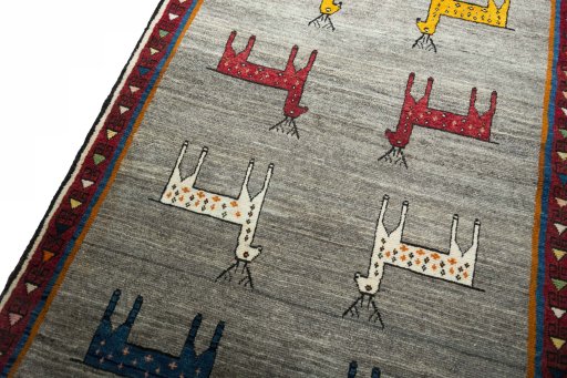 Backside of handmade 2000s Persian Gabbeh rug showing knot structure and weave density