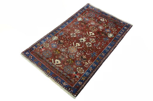 Corner detail of 2000s Persian Gabbeh rug showing border pattern and Wool pile