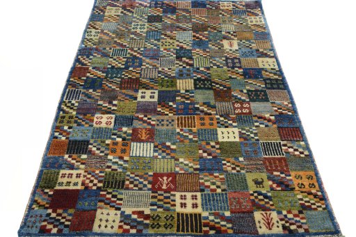 Surface texture of 2000s Persian Gabbeh rug with natural Wool and intricate pattern